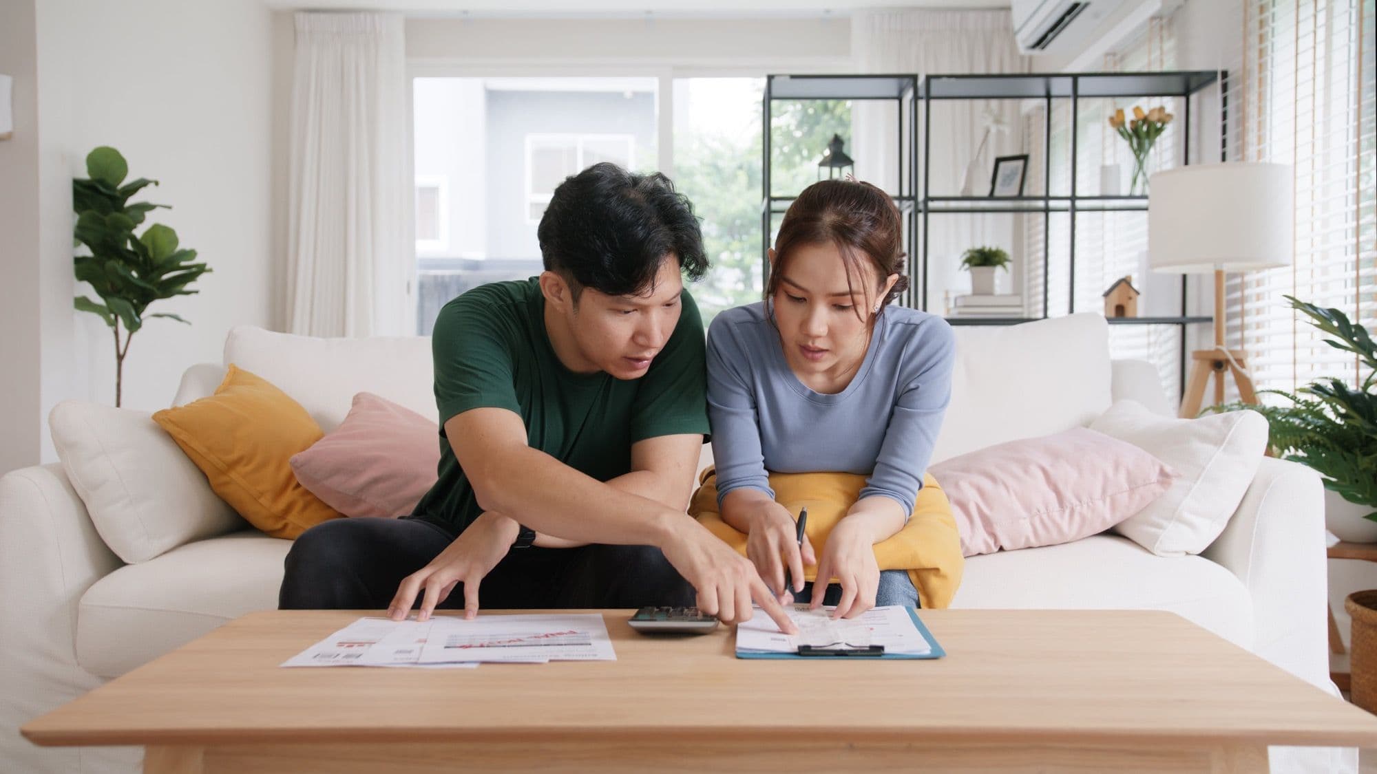A frustrated couple computing costs of living