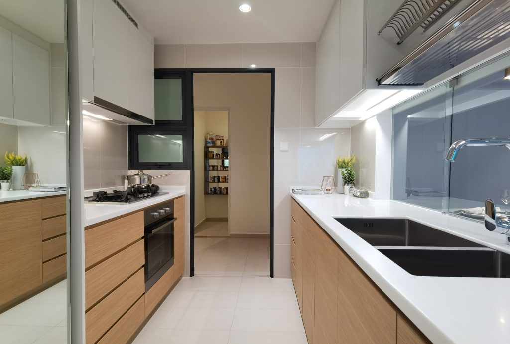An HDB kitchen featuring marble countertops with wooden finish cabinets
