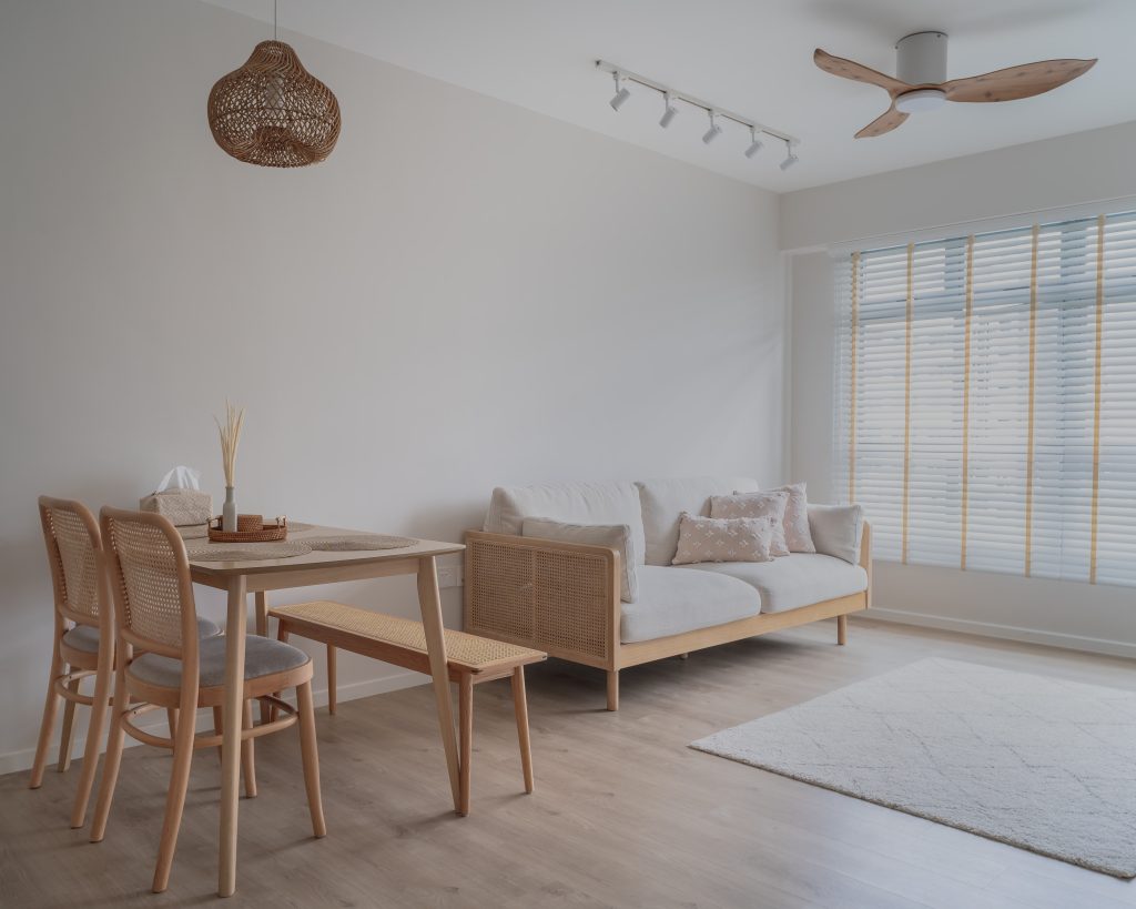 An HDB scandinavian minimalist interior featuring a sofa and dining furniture set.