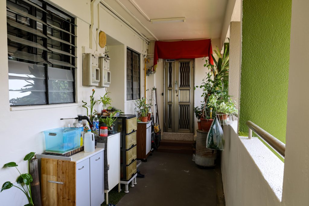 The cluttered front of a Singapore condominium unit's main door